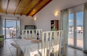 a dining room with a table and a balcony at Apostolos Loft - Cozy Loft in the Center of Preveza in Preveza