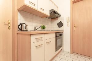 cocina pequeña con fregadero y fogones en Fahrenkrug Wohnung 4, en Scharbeutz