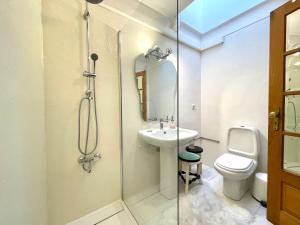 a bathroom with a shower and a sink and a toilet at Sea House in Viana do Castelo +37 photos