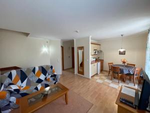 a living room with a couch and a table at Garda Apartman in Hévíz