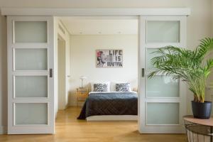 a bedroom with a bed and sliding doors at Old Town Heart XI - Mokotowska in Warsaw