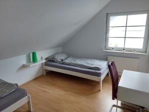 a small room with a bed and a window at Ferienwohnung Frühlingstraße in Mehlbach