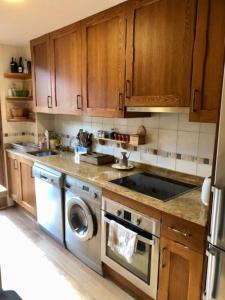 a kitchen with a stove and a dishwasher at Casa Lauré II - PANTICOSA in Panticosa