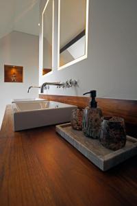 a bathroom with a sink and a mirror at Havenhuis Brugge in Bruges