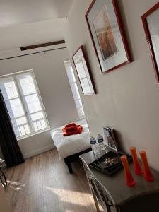 a small room with a bed and a table in it at Auberge de la rose in Anet