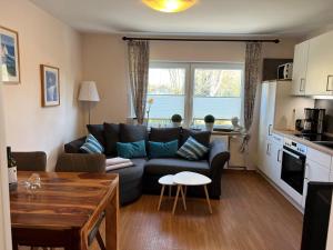 a living room with a couch and a table at Steerenklipp Kieker Bungalow 2 in Borkum