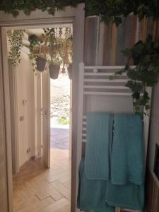 an open door with two blue towels on a chair at B&B Angelica Apartment in Benevento