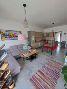 a living room with a couch and a table at the Queen Freddy Penthouse in Taʼ Xbiex