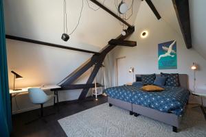 a bedroom with a bed and a desk in it at Havenhuis Brugge in Bruges