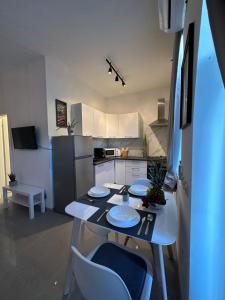 a kitchen with a table and chairs in a room at Apartman Diana in Mali Lošinj