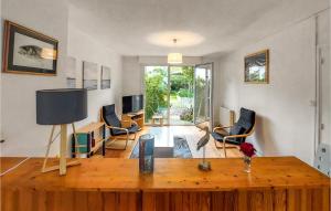 a living room with a wooden table and chairs at Stunning Home In Saint-nazaire With Wifi in Saint-Nazaire