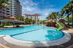 a swimming pool at a resort with a slide at PortDickson Cozy Muji Home 10Pax3BR 1min to beach in Port Dickson