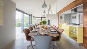 a dining room with a long table and chairs at Quarry House in Kingsbridge