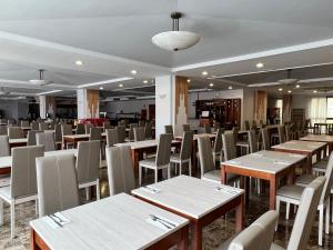 a dining room with wooden tables and chairs at Perla Marina in Nerja