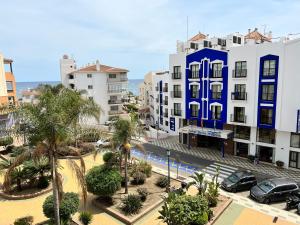 arial view of a city with buildings and palm trees at Perla Marina in Nerja