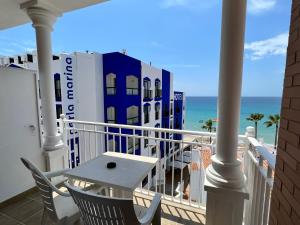 a balcony with a table and a view of the ocean at Perla Marina in Nerja