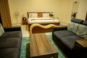 a living room with a bed and two couches at Amariah Villa in Kigali +46 photos