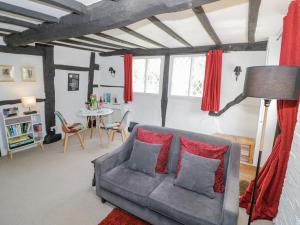 a living room with a couch and a table at Bluebell Cottage in Stratford-upon-Avon