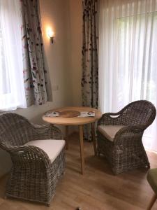 two wicker chairs and a table in a room at Waldhaus in Hinterstoder