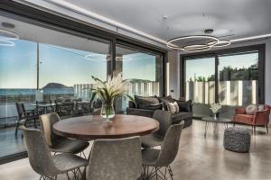 a living room with a table and chairs at Villa V Beach Villa, All Inclusive Board, by ZanteWize in Laganas