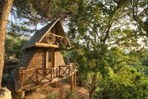 a small tree house sitting in the woods at Captain Ikaros in Agios Kirykos