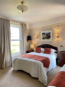 a bedroom with a large bed and a window at The Raffles in Exeter