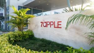 a sign on a wall in front of a building at 7 Apple Hotel Aurangabad in Aurangabad