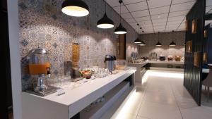 a kitchen with a counter with aasteryasteryasteryasteryasteryasteryasteryasteryastery at 7 Apple Hotel Aurangabad in Aurangabad