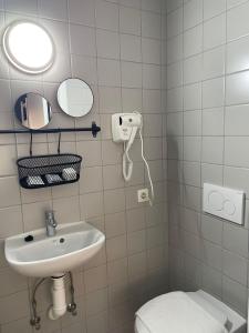 a bathroom with a sink and a toilet at Hotel HEB in Ostend