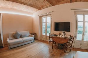 a living room with a couch and a table at LA CASCINA DI CARLOTTA 1846 agriturismo in Alba