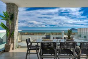 a dining room with a view of the ocean at Villa V Beach Villa, All Inclusive Board, by ZanteWize in Laganas +53 photos