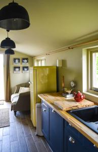 a kitchen with a counter and a sink and a couch at Gite Un Le Terrail in Villard