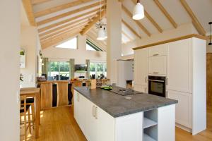 a kitchen with white cabinets and a counter top at HeiDeluxe Landhaus mit Sauna in Soltau