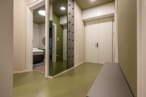 a hallway with a mirror and a room with a bed at Green, deluxe two bedroom suite in Split