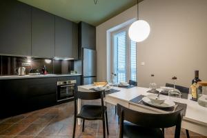 a kitchen with a table and chairs in a kitchen at Green, deluxe two bedroom suite in Split