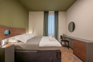 a hotel room with a bed and a desk at Green, deluxe two bedroom suite in Split