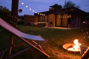 a fire pit in the yard of a house at night at 't Bunga huiske in Lanaken