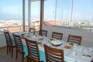 a dining room with a table with plates of food at Dort Mevsim Suit Hotel in Çanakkale