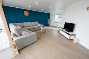a living room with a couch and a tv at La Ruchette in Anthée
