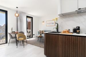 a kitchen and living room with a table and chairs at TSA La Rambla in Barcelona