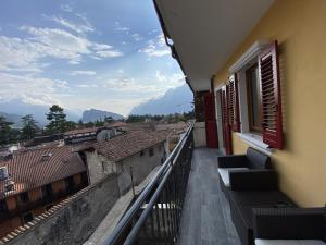 a balcony with chairs and a view of a city at East West Room in Arco