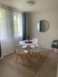 a dining room with a table and chairs and a mirror at Plush 2 bedroom apartment Kingston in Kingston 