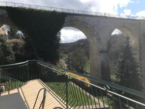 a stone bridge with a train under it at gite du viaduc in Semur-en-Auxois