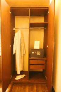a closet with a cabinet with a microwave and acomputer at Royal Garden Hotel in Beirut
