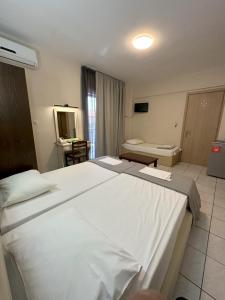 Posteľ alebo postele v izbe v ubytovaní Hotel Afrodite
