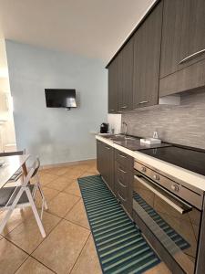 a kitchen with wooden cabinets and a sink and a table at Villa Santo Stefano in Monopoli