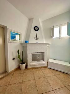 a living room with a fireplace and a window at Villa Santo Stefano in Monopoli