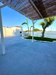 a patio with a view of the water and trees at Villa Santo Stefano in Monopoli