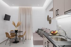 uma cozinha e sala de estar com um sofá e uma mesa em Petros Studios & Suites em Naxos Chora