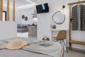 a bedroom with a bed with a hat on it at Petros Studios & Suites in Naxos Chora